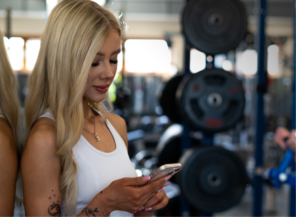 Gym girl holding mobile phone